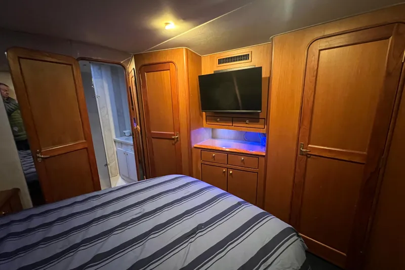 Slide: The Image of Luxurious cabin interior of 1999 Ocean Yachts 56 Super Sport with wood paneling and TV. - 41