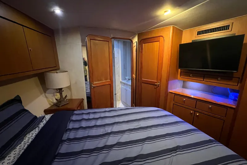 Slide: The Image of Luxurious cabin interior of 1999 Ocean Yachts 56 Super Sport with wood finishes and modern amenities. - 42