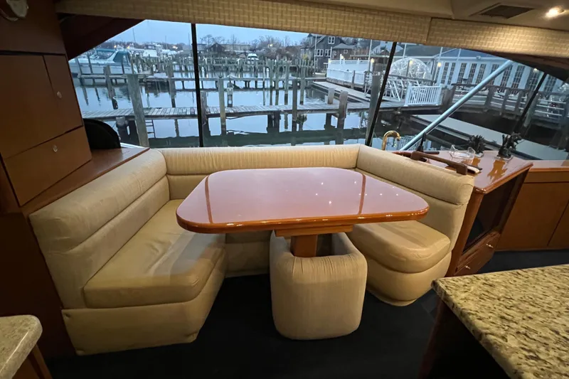Slide: The Image of Interior of 1999 Ocean Yachts 56 Super Sport with dining area and marina view. - 53