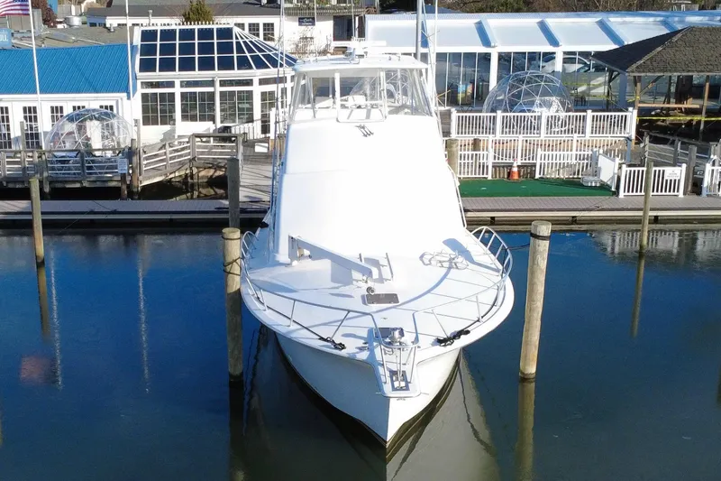 Slide: The Image of 1999 Ocean Yachts 56 Super Sport docked at marina, front view. - 9