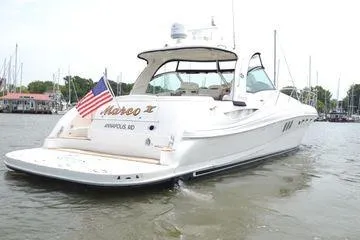 Slide: The Image of 2007 Sea Ray Sundancer 520 yacht on water, displaying American flag. - 2