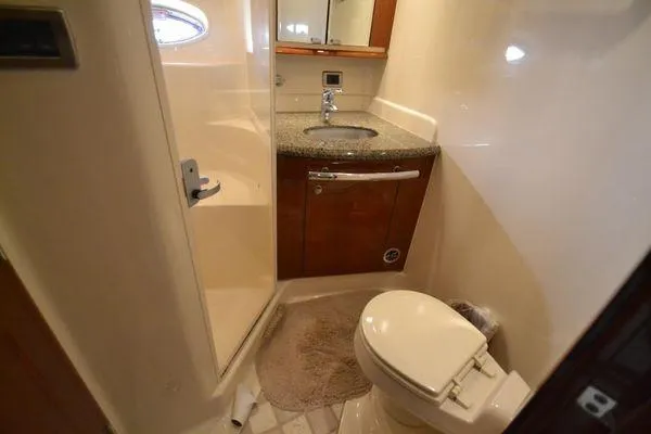 Slide: The Image of 2007 Sea Ray Sundancer 520 yacht bathroom with sink, toilet, and shower. - 24