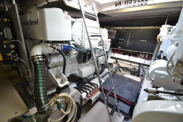 Slide: The Image of Engine room of 2007 Sea Ray Sundancer 520 yacht, featuring diesel engines and equipment. - 27