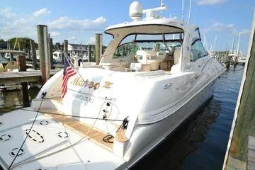 Slide: The Image of 2007 Sea Ray Sundancer 520 yacht docked at marina, featuring sleek design and American flag. - 4