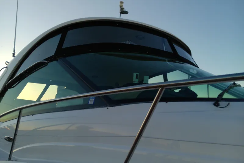 Slide: The Image of 2007 Sea Ray Sundancer 520 yacht, close-up of sleek windshield and railing at sunset. - 6