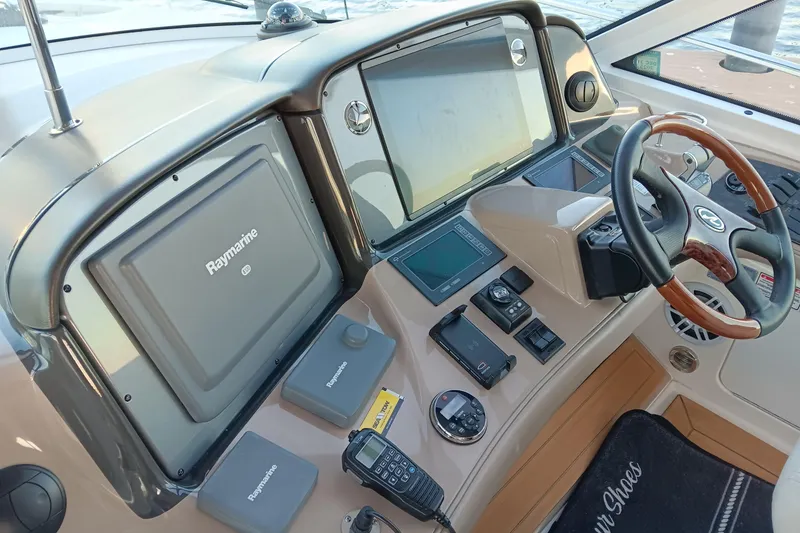 Slide: The Image of 2007 Sea Ray Sundancer 520 helm with Raymarine navigation system and modern controls. - 7