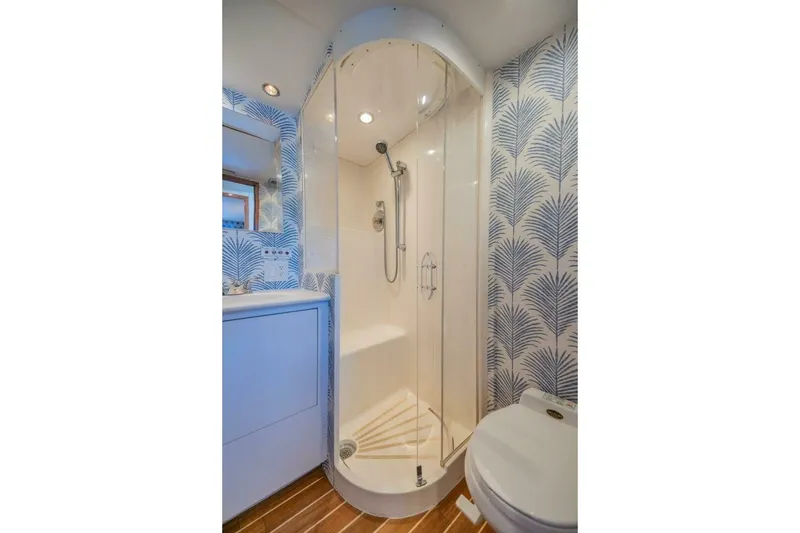 Slide: The Image of Bathroom interior of 1999 Hatteras 52 Sport Deck Motor Yacht with shower and patterned wallpaper. - 14