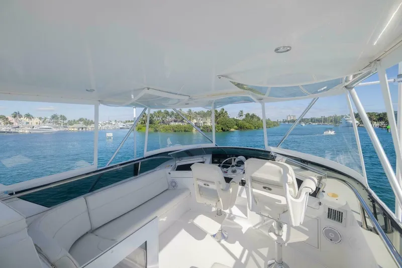 Slide: The Image of 1999 Hatteras 52 Sport Deck Motor Yacht helm with ocean view and luxurious seating. - 3