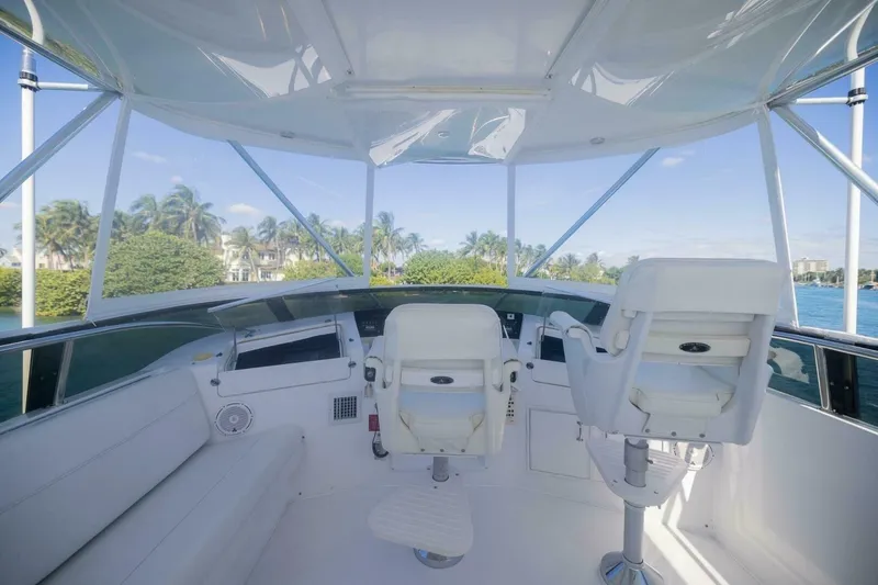 Slide: The Image of Cockpit of 1999 Hatteras 52 Sport Deck Motor Yacht with white seating and ocean view. - 4