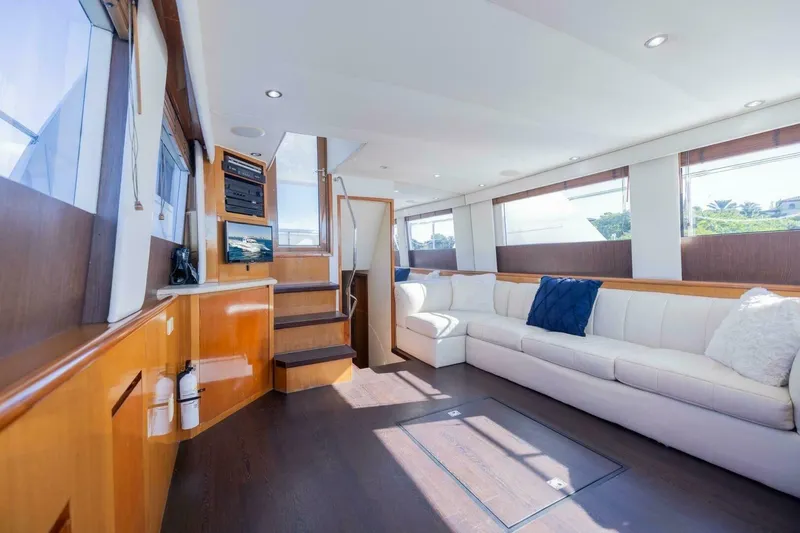 Slide: The Image of Luxurious interior of 1999 Hatteras 52 Sport Deck Motor Yacht with white seating and wood accents. - 6
