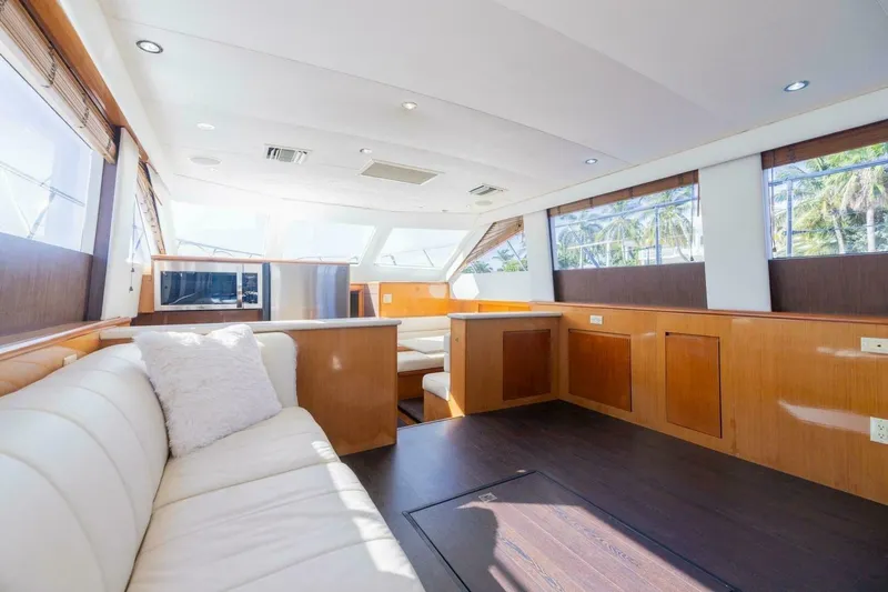 Slide: The Image of Luxurious interior of 1999 Hatteras 52 Sport Deck Motor Yacht with elegant wood finishes. - 7