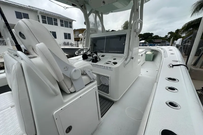 Slide: The Image of 2012 Yellowfin 32 Offshore boat interior with helm and seating area. - 1