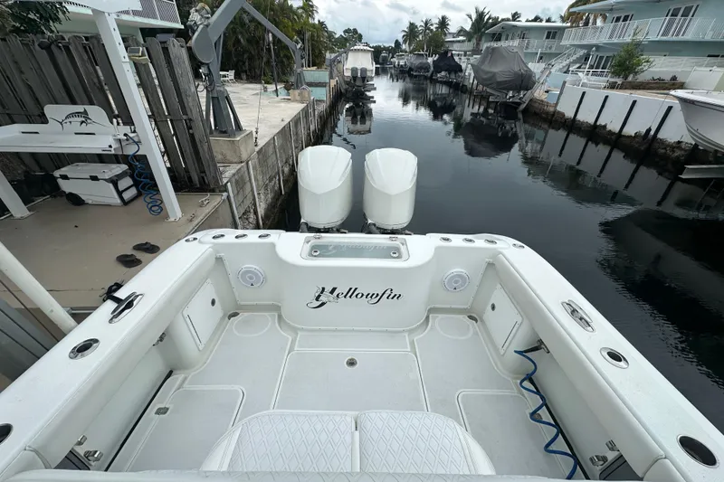 Slide: The Image of 2012 Yellowfin 32 Offshore boat docked in a serene canal setting. - 7