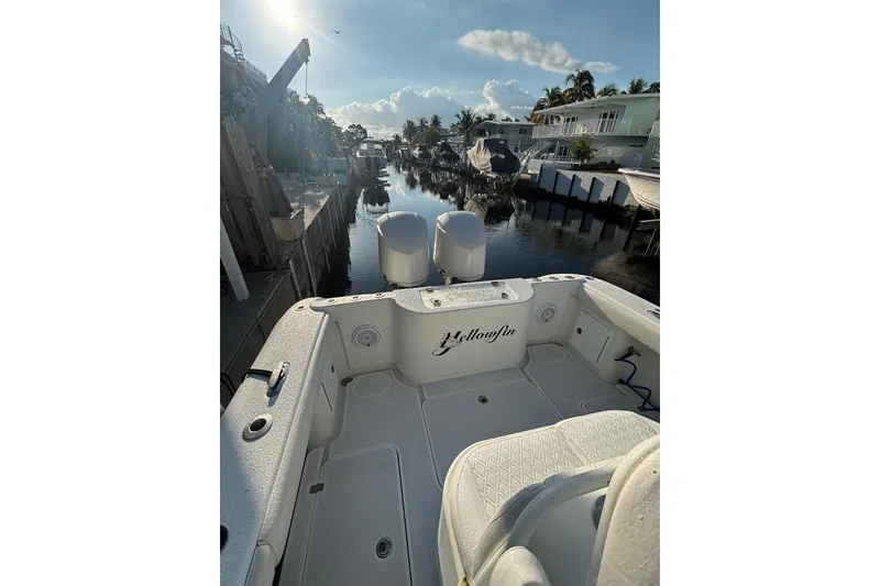 Slide: The Image of 2012 Yellowfin 32 Offshore boat docked in a scenic canal setting. - 8