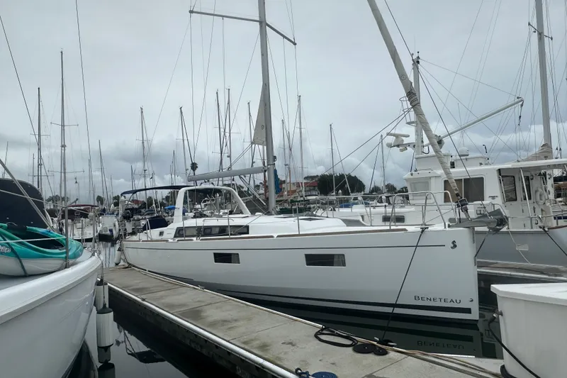 Slide: The Image of 2019 Beneteau Oceanis 38.1 sailboat docked in a marina. - 1