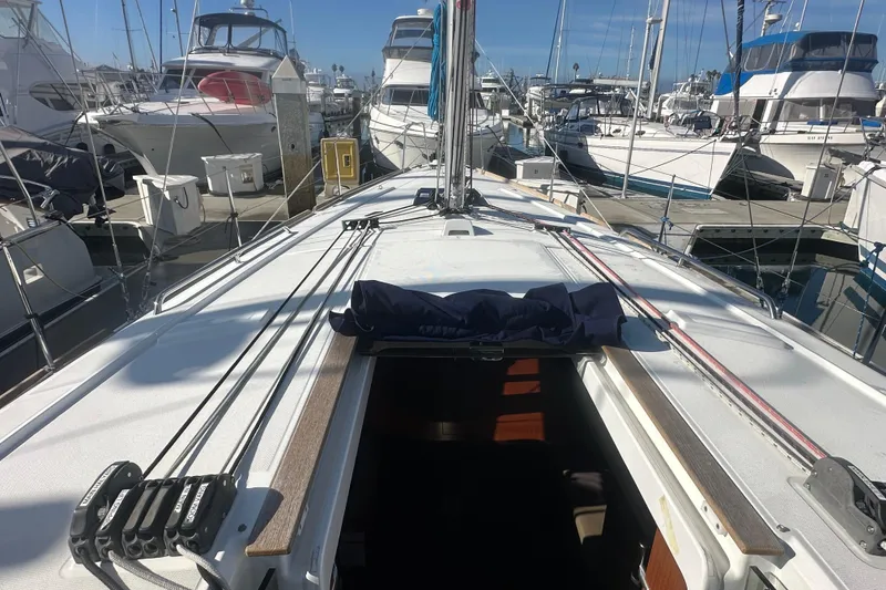 Slide: The Image of 2019 Beneteau Oceanis 38.1 sailboat docked at marina, view of deck and cockpit. - 16