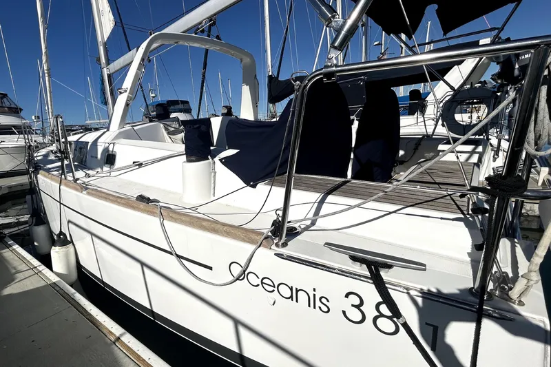 Slide: The Image of 2019 Beneteau Oceanis 38.1 sailboat docked at marina under clear blue sky. - 3