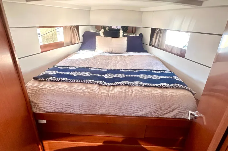 Slide: The Image of Cozy bedroom in 2019 Beneteau Oceanis 38.1 yacht with elegant bedding and natural light. - 5