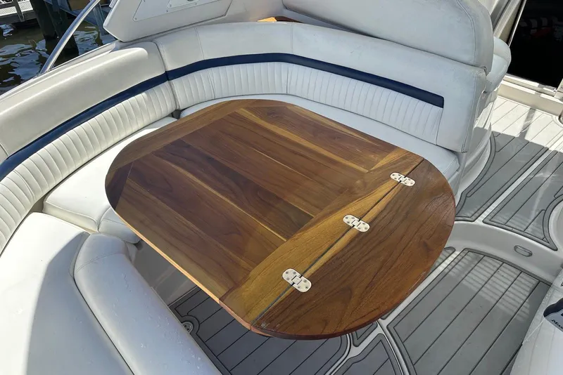 Slide: The Image of 2009 Monterey 350 Sport Yacht interior with wooden table and white seating. - 12
