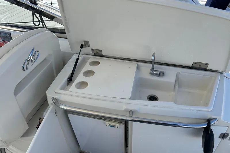 Slide: The Image of 2009 Monterey 350 Sport Yacht wet bar with sink and storage. - 14
