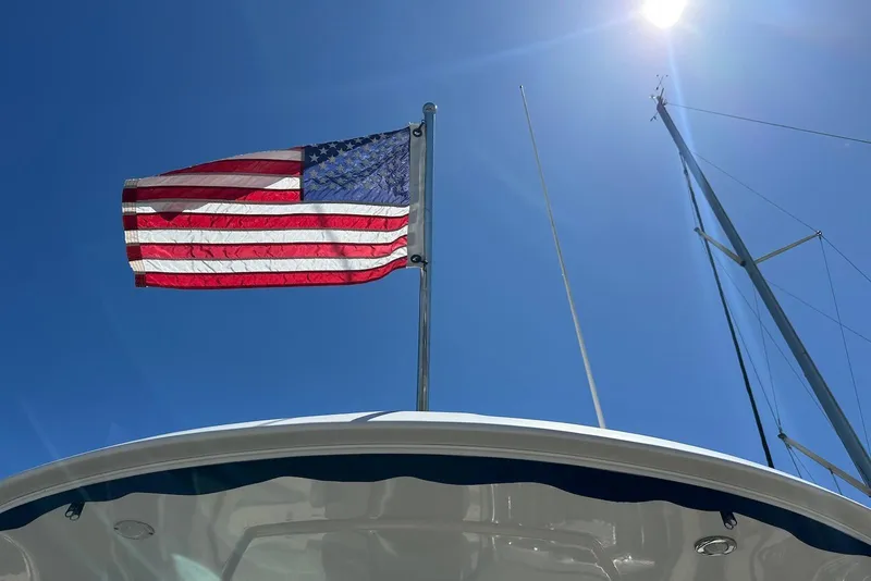 Slide: The Image of American flag on 2009 Monterey 350 Sport Yacht under clear blue sky. - 15
