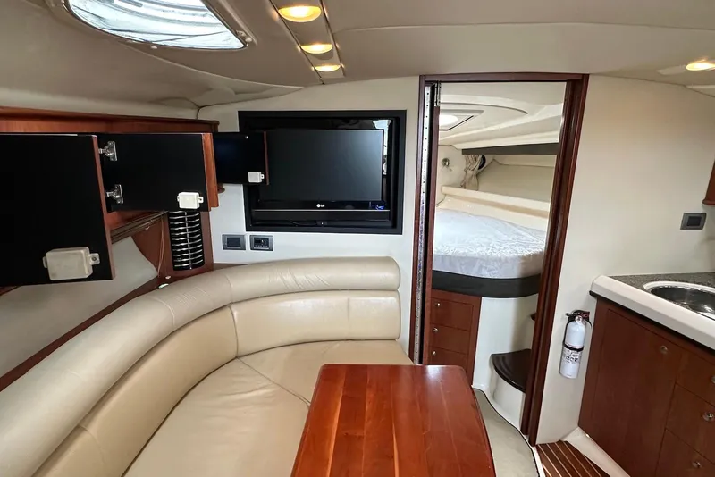Slide: The Image of Interior of 2009 Monterey 350 Sport Yacht with leather seating, TV, and cozy cabin. - 16