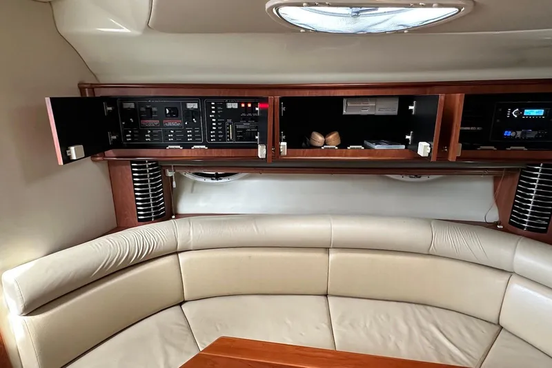 Slide: The Image of Interior of a 2009 Monterey 350 Sport Yacht with open cabinets and beige seating. - 20