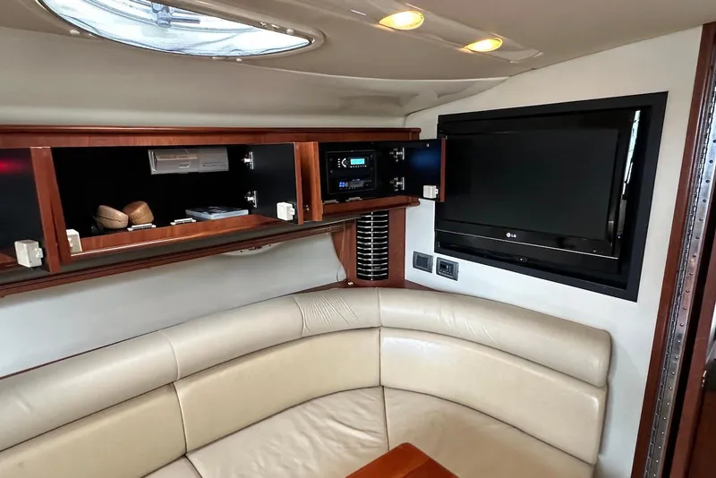 Slide: The Image of Interior of 2009 Monterey 350 Sport Yacht with TV, cabinets, and leather seating. - 21