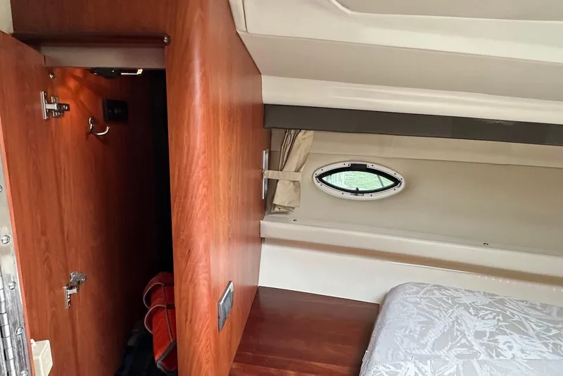 Slide: The Image of 2009 Monterey 350 Sport Yacht interior with wood paneling and porthole window. - 22