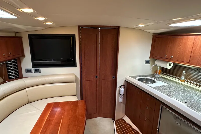 Slide: The Image of Interior of 2009 Monterey 350 Sport Yacht with kitchen and seating area. - 29