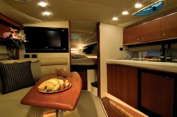 Slide: The Image of Luxury seating area on 2009 Monterey 350 Sport Yacht with wooden table. - 3