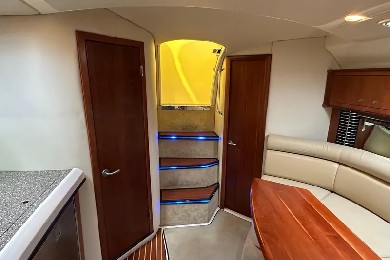 Slide: The Image of Interior of 2009 Monterey 350 Sport Yacht with stairs, seating, and wooden accents. - 30
