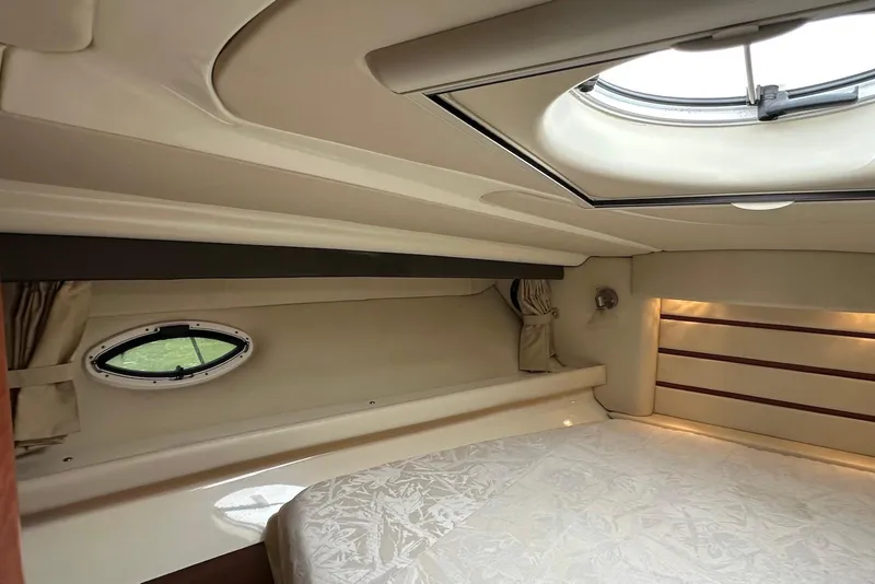 Slide: The Image of 2009 Monterey 350 Sport Yacht cabin interior with bed, porthole, and skylight. - 31