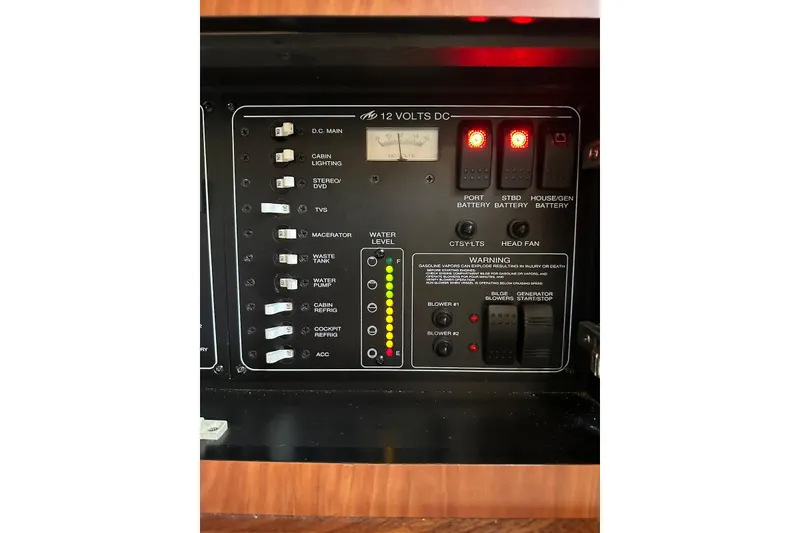 Slide: The Image of Control panel of a 2009 Monterey 350 Sport Yacht, featuring various switches and indicators. - 33