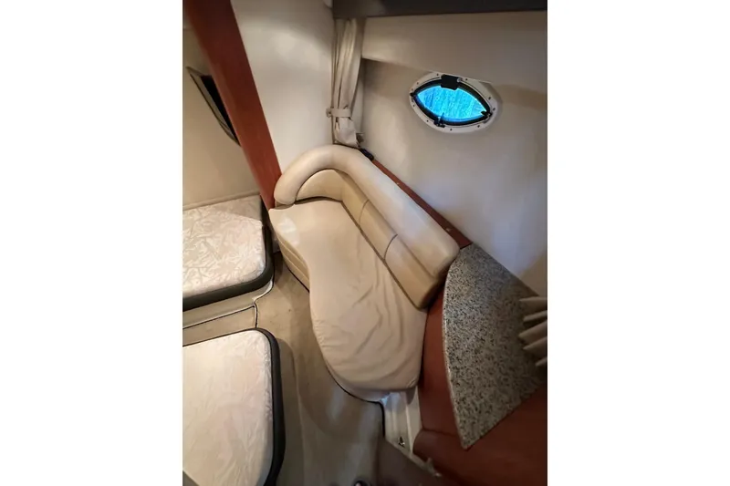 Slide: The Image of Interior of 2009 Monterey 350 Sport Yacht with beige seating and small window. - 35