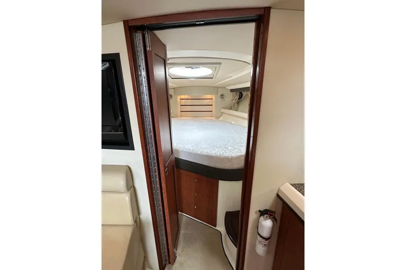 Slide: The Image of 2009 Monterey 350 Sport Yacht interior cabin with bed and wooden accents. - 36