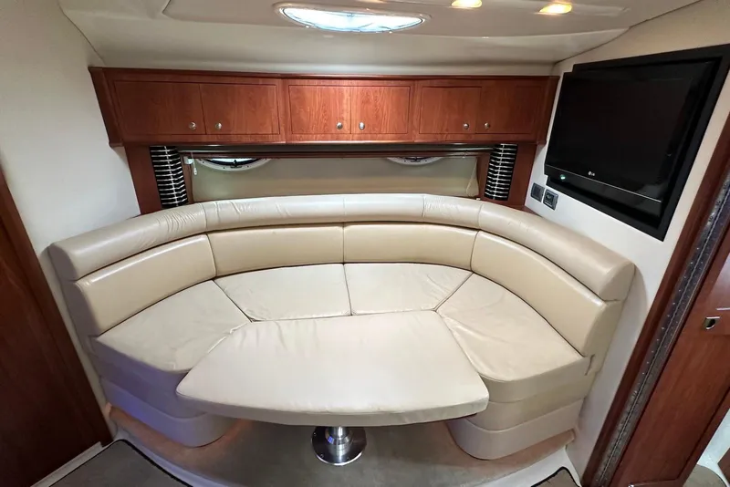 Slide: The Image of Luxurious interior of 2009 Monterey 350 Sport Yacht with curved leather seating and wood cabinetry. - 44