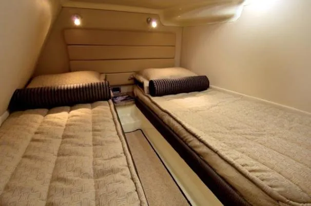 Slide: The Image of 2009 Monterey 350 Sport Yacht on stands, blue and white exterior, outdoor setting. - 5