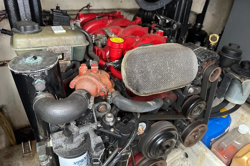 Slide: The Image of Engine compartment of a 2009 Monterey 350 Sport Yacht, showcasing mechanical components and belts. - 50