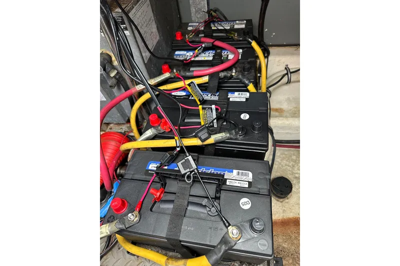 Slide: The Image of Battery setup in a 2009 Monterey 350 Sport Yacht with connected cables. - 53