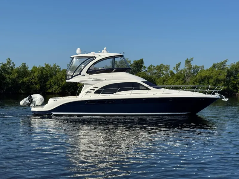 The Image of 2007 Sea Ray 52 Sedan Bridge yacht cruising on calm water. - 0