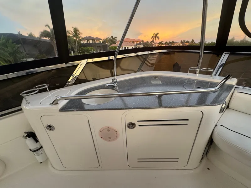 Slide: The Image of 2007 Sea Ray 52 Sedan Bridge yacht interior with sleek countertop and sunset view. - 15