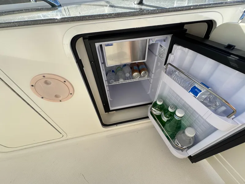 Slide: The Image of Mini fridge stocked with beverages on a 2007 Sea Ray 52 Sedan Bridge yacht. - 16