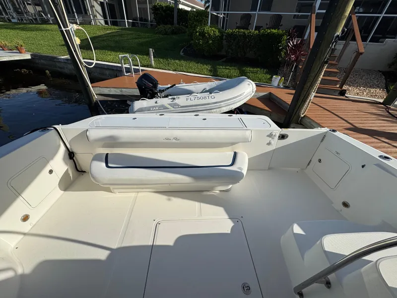 Slide: The Image of 2007 Sea Ray 52 Sedan Bridge yacht deck with seating and docked inflatable boat. - 17