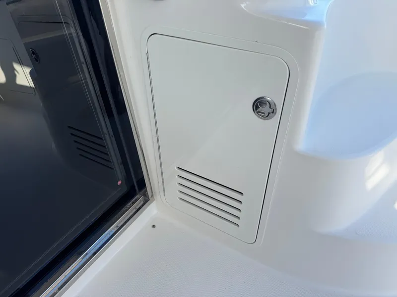 Slide: The Image of 2007 Sea Ray 52 Sedan Bridge interior detail, featuring a white storage compartment. - 18