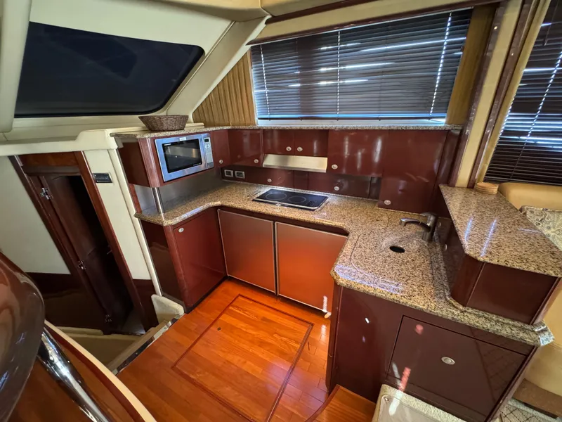 Slide: The Image of Luxurious kitchen interior of 2007 Sea Ray 52 Sedan Bridge yacht with modern amenities. - 26
