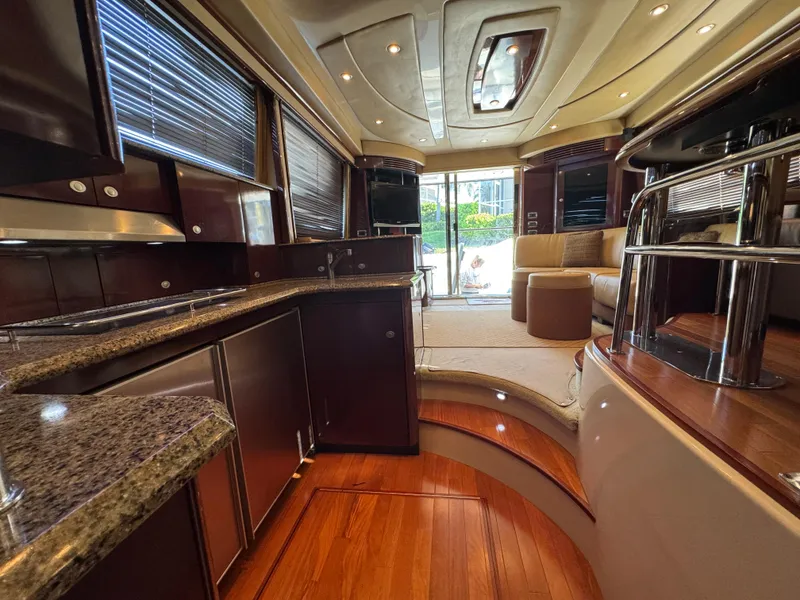 Slide: The Image of Luxurious interior of 2007 Sea Ray 52 Sedan Bridge yacht with elegant wood finishes. - 27