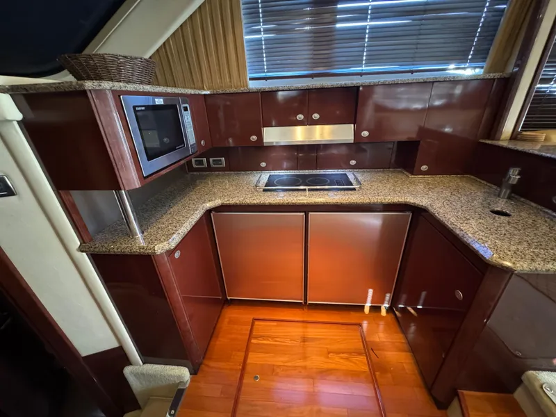 Slide: The Image of Luxurious kitchen interior of 2007 Sea Ray 52 Sedan Bridge yacht with granite countertops. - 28