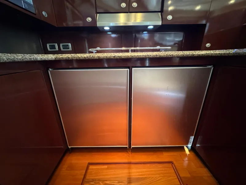 Slide: The Image of Luxurious kitchen area in 2007 Sea Ray 52 Sedan Bridge yacht with wood cabinetry. - 29