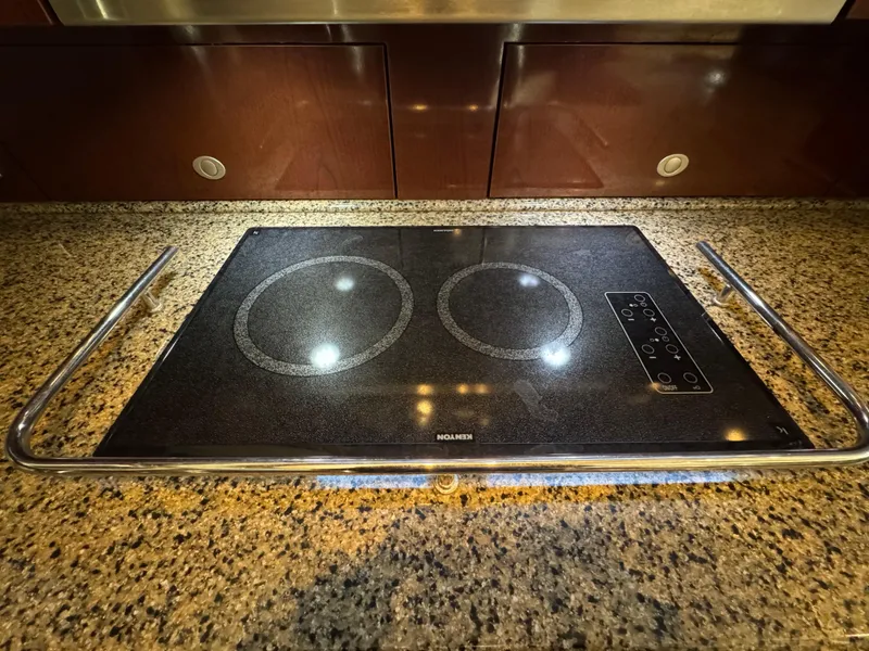 Slide: The Image of Granite countertop with a sleek electric cooktop on a 2007 Sea Ray 52 Sedan Bridge. - 31